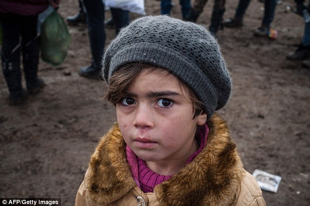 At least 10,000 refugee children have vanished after arriving in Europe with some being forced into sex work and slavery, officials believe. Above, a child waits with other migrants and refugees for security check after crossing the Macedonian border into Serbia on Friday. It is not known if the boy was by himself