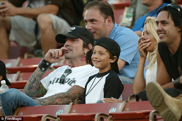Hearthrob status: Dylan (pictured with Tommy in 2003) is significantly less tatted-up that his dad