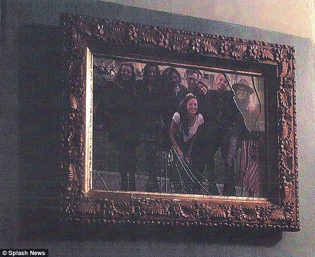 Photographs of a smashed photo frame (pictured), broken glass, a discarded wine bottle and what appeared to be wine stains were included as exhibits in the restraining order Heard filed