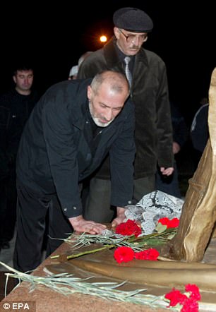 Vitaly Kaloyev (left) who has since been released from a Swiss prison, stands at a monument for Beslan siege victims upon his return to Vladikavkaz in 2007